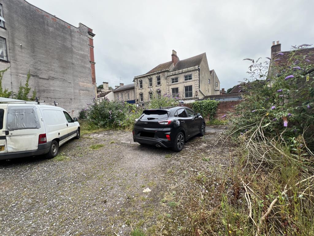 Lot: 100 - FORMER TRANSPORT YARD WITH POTENTIAL - View of the site looking towards High Street